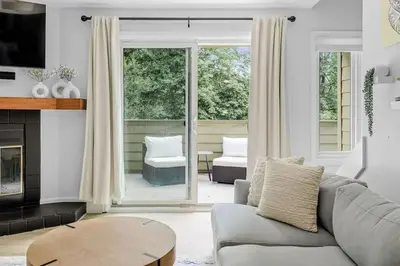 a living room with a couch and a fireplace at Bright & Modern - King Suite - Creekside Trail in Boulder
