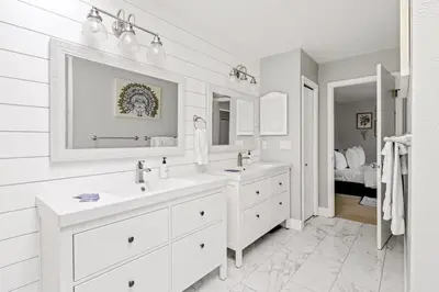 a white bathroom with two sinks and a mirror at Bright & Modern - King Suite - Creekside Trail in Boulder