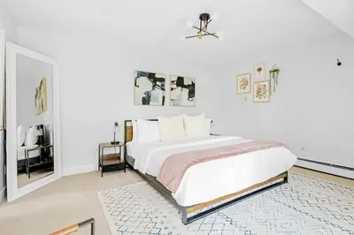 a white bedroom with a bed and a rug at Bright & Modern - King Suite - Creekside Trail in Boulder