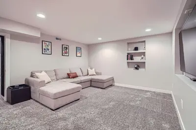 a living room with a couch and a tv at Spacious Denver home in Denver