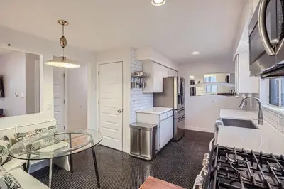 a kitchen with a glass table and a counter top at Spacious Denver home in Denver