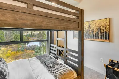 a bedroom with a bunk bed with a large window at 3 Mi to Winter Park Resort Mtn-View Haven! in Winter Park