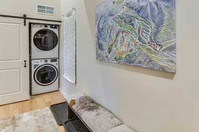 a laundry room with a washing machine and a painting at 3 Mi to Winter Park Resort Mtn-View Haven! in Winter Park