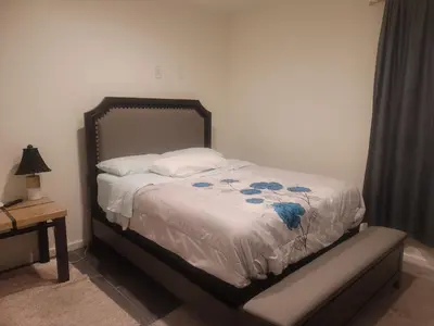 a bedroom with a bed with blue flowers on it at Ram comfort in DEN
