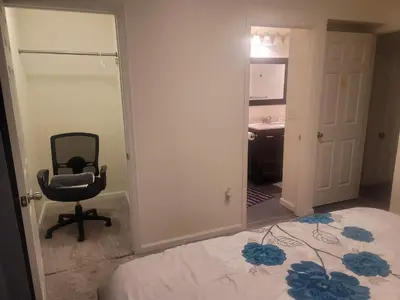 a bedroom with a bed and a chair and a mirror at Ram comfort in DEN