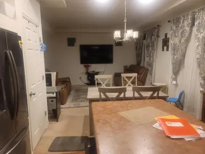a kitchen and living room with a table and a refrigerator at Ram comfort in DEN