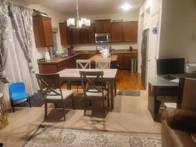 a kitchen and dining room with a table and chairs at Ram comfort in DEN