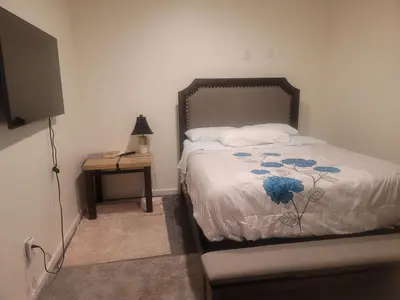 a bedroom with a bed and a night stand with a television at Ram comfort in DEN