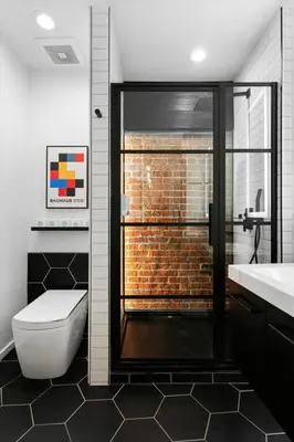 a bathroom with a toilet and a glass shower at Suite No 1 in Denver