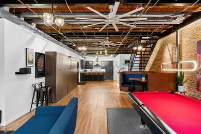 a living room with a pool table in a room with a ceiling at Suite No 1 in Denver