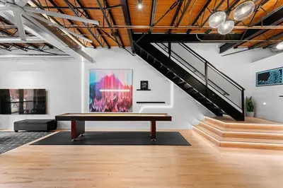 a bench in the middle of a room with a staircase at Suite No 2 in Denver