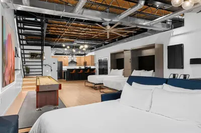 a hotel room with two beds and a kitchen at Suite No 2 in Denver