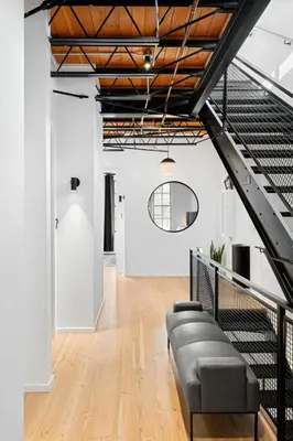 a living room with a couch and a staircase at Suite No 2 in Denver