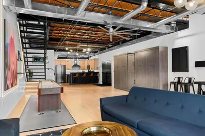 a living room with a blue couch and a table at Suite No 2 in Denver