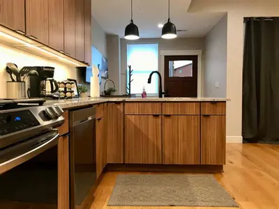 a kitchen with wooden cabinets and a sink at R & R Hideaway in Grand Lake