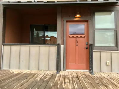 a red door on the front of a house at R & R Hideaway in Grand Lake