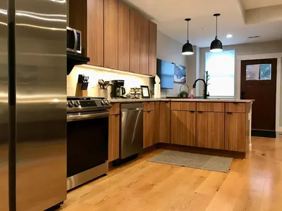 a kitchen with a stainless steel refrigerator and wooden cabinets at R & R Hideaway in Grand Lake