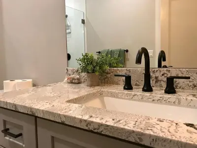 a bathroom counter with a sink and a mirror at R & R Hideaway in Grand Lake
