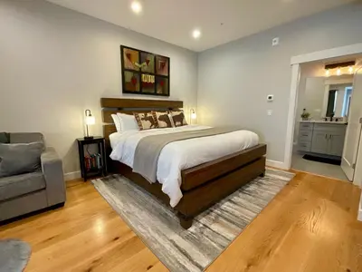 a bedroom with a large bed and a couch at R & R Hideaway in Grand Lake