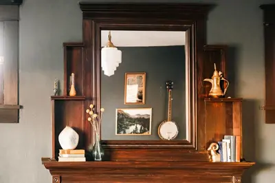 a mirror on top of a mantle with a guitar at Exquisite Craftsman - RiNo&Cole - Backyard Garden in Denver