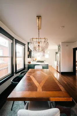 a dining room with a wooden table and a chandelier at Exquisite Craftsman - RiNo&Cole - Backyard Garden in Denver