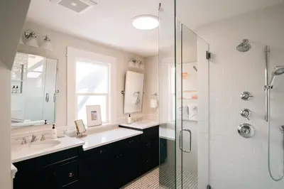 a bathroom with two sinks and a glass shower at Exquisite Craftsman - RiNo&Cole - Backyard Garden in Denver