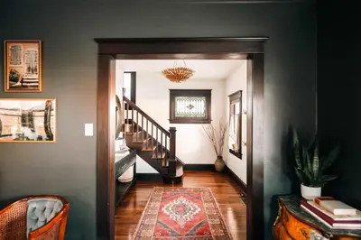 a hallway with a staircase with a rug and a stair case at Exquisite Craftsman - RiNo&Cole - Backyard Garden in Denver