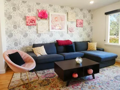 a living room with a blue couch and a table at Entire House Kid Ready Yard in Arvada