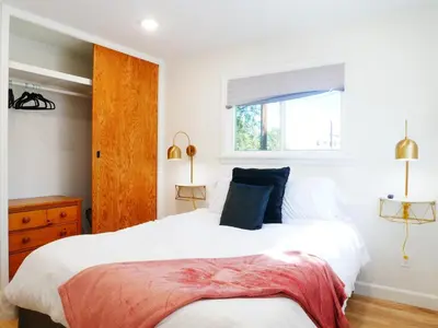 a bedroom with a large white bed and a window at Entire House Kid Ready Yard in Arvada