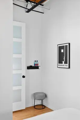 a chair in a room with a white wall at Suite No 1 & No 2 in Denver