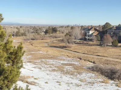 a field with snow on the ground and houses at Modern Haven Scenic Nature Views Near Chatfield Park in Littleton