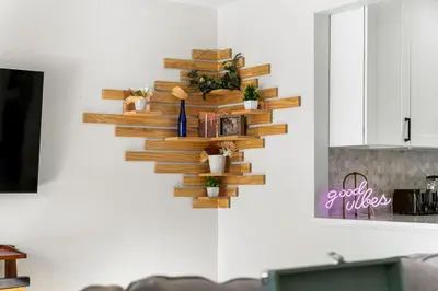 a wooden wall shelf on a kitchen wall with potted plants at Modern Family Friendly Escape Central 5 Bedroom in Denver