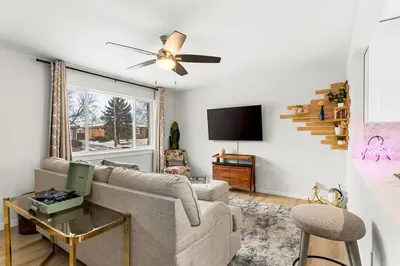 a living room with a couch and a tv at Modern Family Friendly Escape Central 5 Bedroom in Denver
