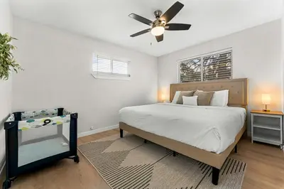 a bedroom with a bed and a ceiling fan at Modern Family Friendly Escape Central 5 Bedroom in Denver