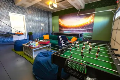 a room with a pool table in a room at Spacious 4BD Near Denver w BBQ, Game Room & Office in Commerce City