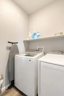 a laundry room with a washer and dryer at Spacious 4BD Near Denver w BBQ, Game Room & Office in Commerce City