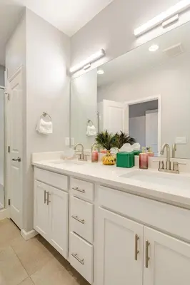 a bathroom with two sinks and a large mirror at Spacious 4BD Near Denver w BBQ, Game Room & Office in Commerce City