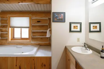 a bathroom with a tub and a sink at Silverthorne Cabin with Hot Tub and Forest Access in Silverthorne