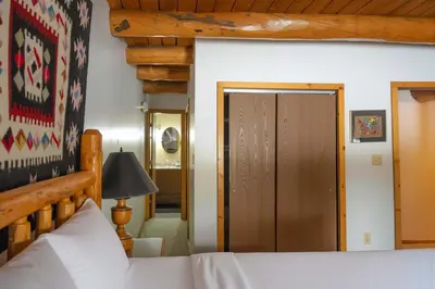 a bedroom with a bed and a wooden door at Silverthorne Cabin with Hot Tub and Forest Access in Silverthorne