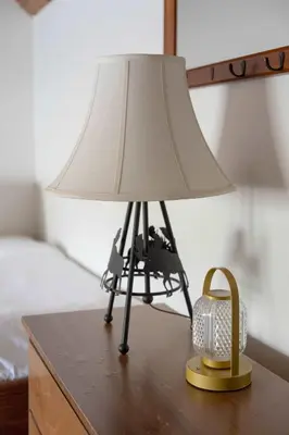 a lamp on top of a table with a basket at Silverthorne Cabin with Hot Tub and Forest Access in Silverthorne