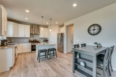 a kitchen with white cabinets and a table and chairs at Hike, Bike and More Superior Home 3 Mi to Parks! in Superior