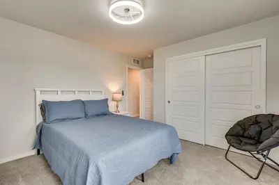 a bedroom with a blue bed and a chair at Hike, Bike and More Superior Home 3 Mi to Parks! in Superior