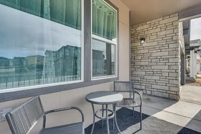 a patio with two chairs and a table and two windows at Hike, Bike and More Superior Home 3 Mi to Parks! in Superior