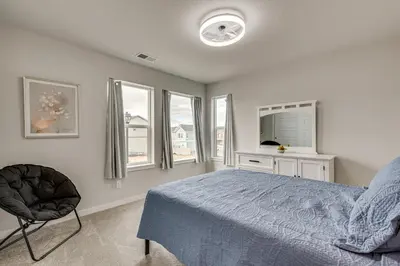 a bedroom with a bed and a chair and windows at Hike, Bike and More Superior Home 3 Mi to Parks! in Superior