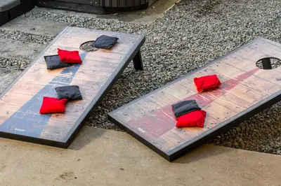 a picnic table with red and black pillows on it at Huge Hot Tub, Theater Room, Family Friendly Oasis in Arvada