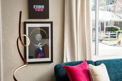 a picture frame on a wall next to a couch at Huge Hot Tub, Theater Room, Family Friendly Oasis in Arvada