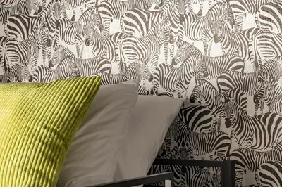 a green pillow sitting next to a wall with zebras at Huge Hot Tub, Theater Room, Family Friendly Oasis in Arvada