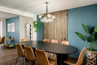 a dining room with a black table and chairs at Huge Hot Tub, Theater Room, Family Friendly Oasis in Arvada