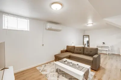 a living room with a couch and a table at 8 Mi to Dtwn Denver Haven with Patio and Yard! in Denver