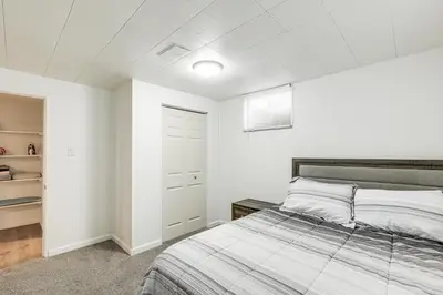a white bedroom with a bed and a closet at 8 Mi to Dtwn Denver Haven with Patio and Yard! in Denver